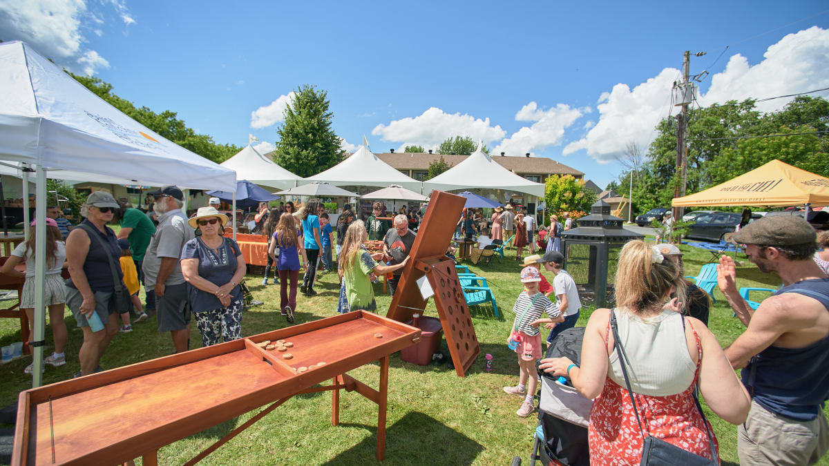 Giant wood games and tents outside.