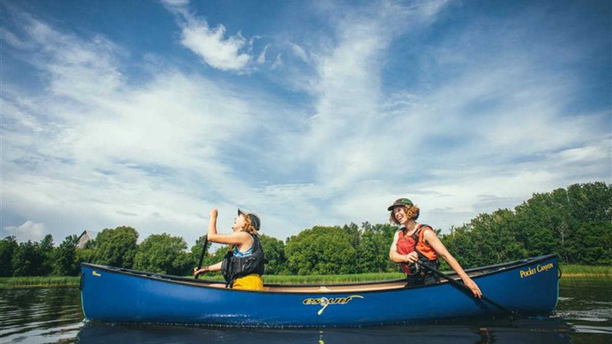 Two people in a blue canoe.