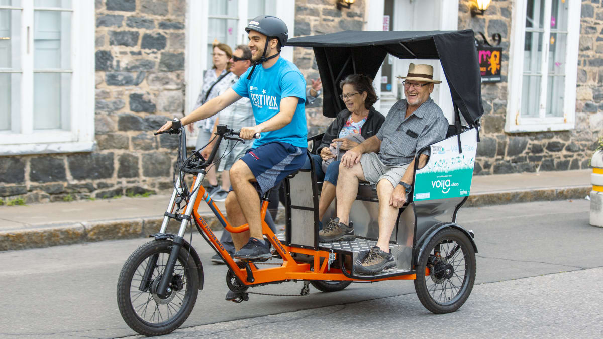 Couple taking advantage of an eco-friendly mode of transportation.