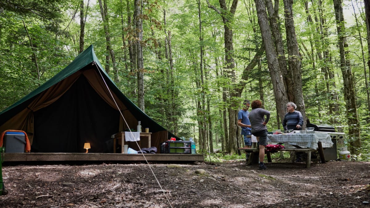 Canvas tents in the woods at Huttopia Sutton.