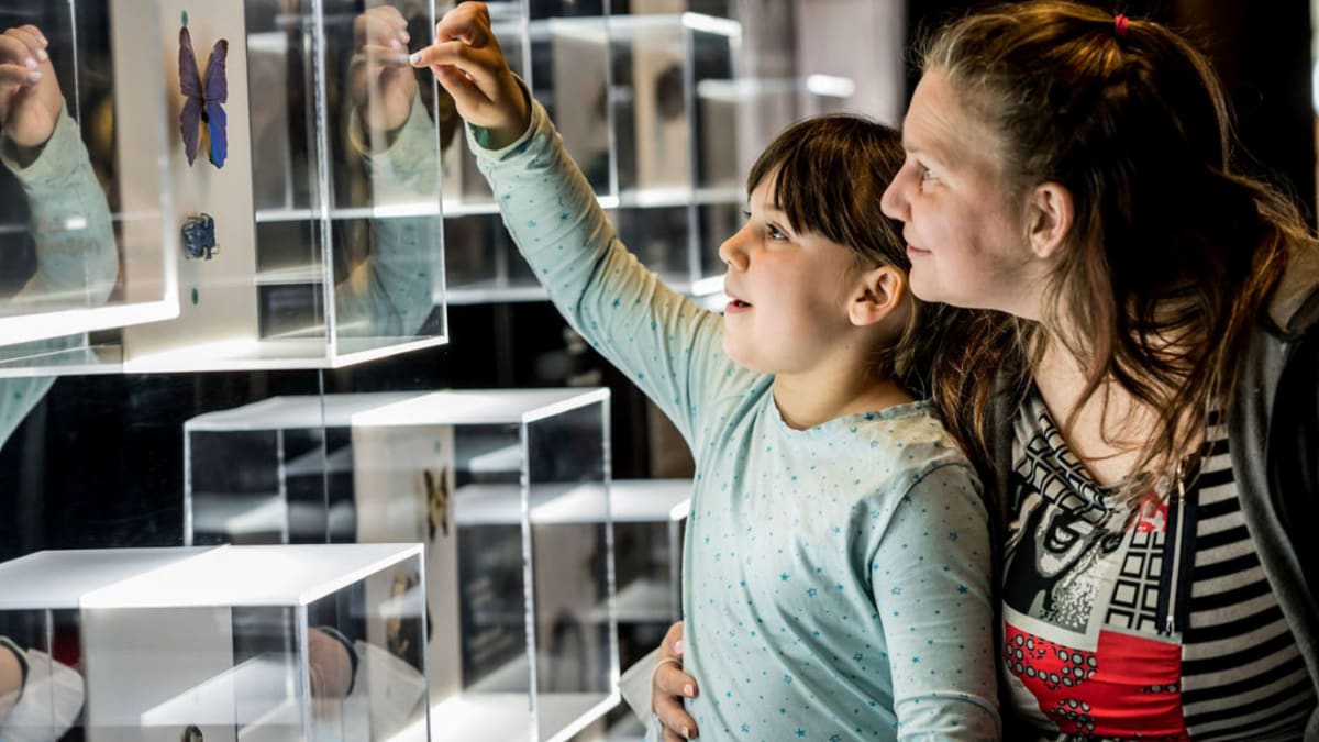 Mother and daughter looking at an exhibit.