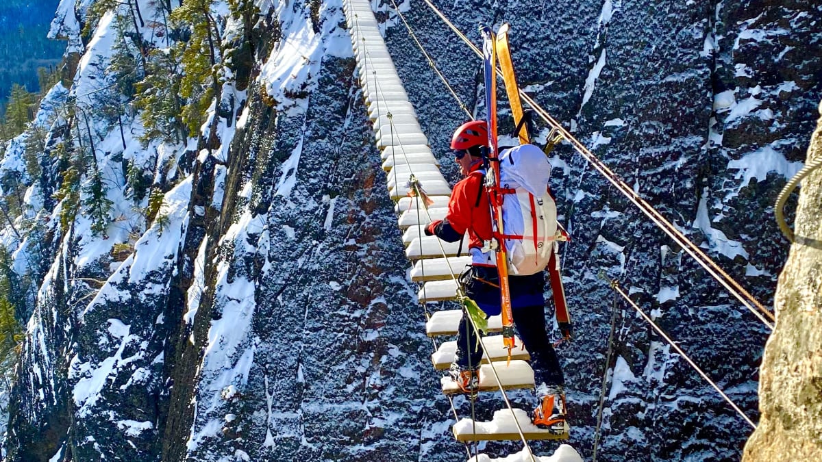 The suspension bridge of a via ferrata course under the snow