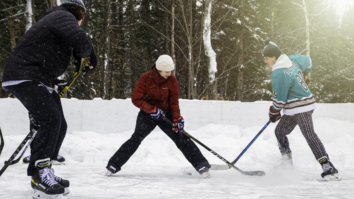 Three men playing ice hockey.