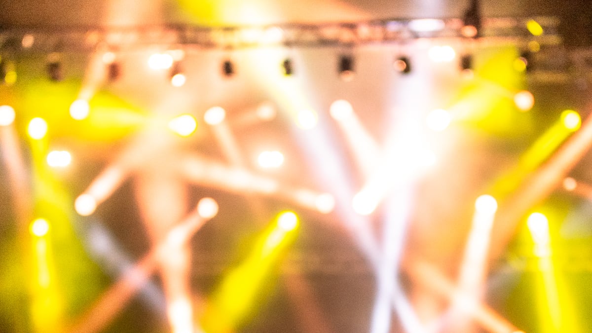 Stage with lights during a show in the late evening during the Innu Nikamu festival.