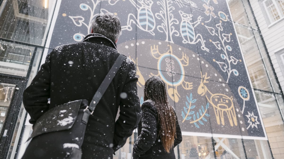 A man and a woman looking at a mural