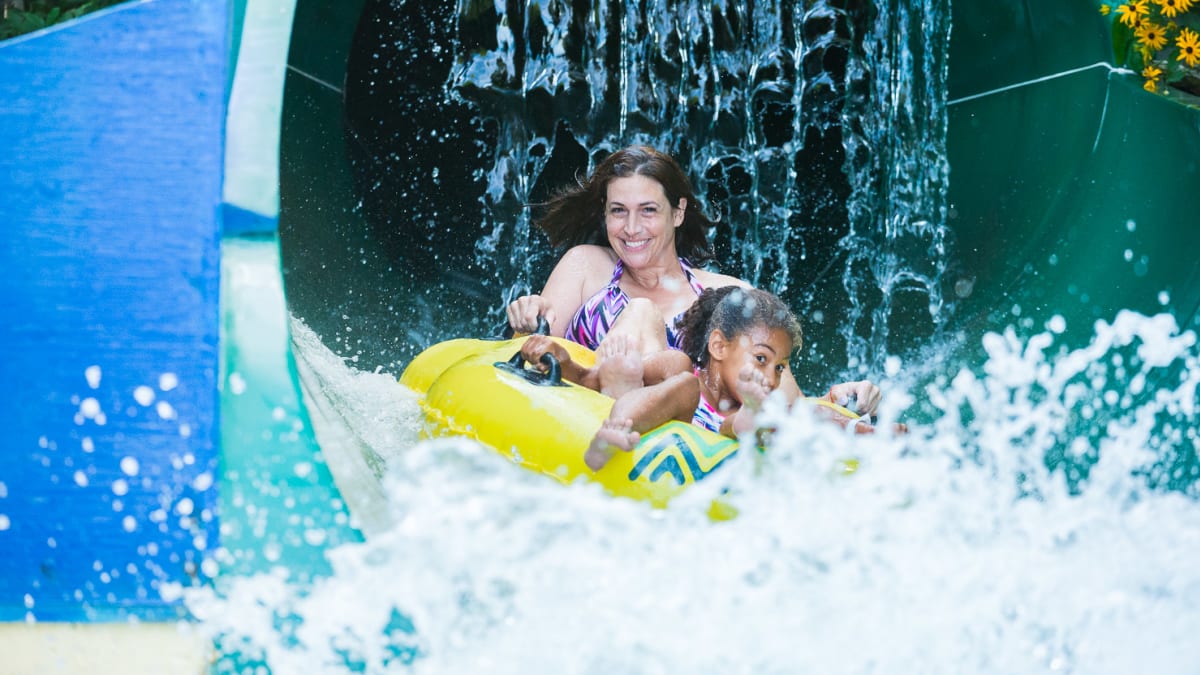 Mother and daughter on a water slide.