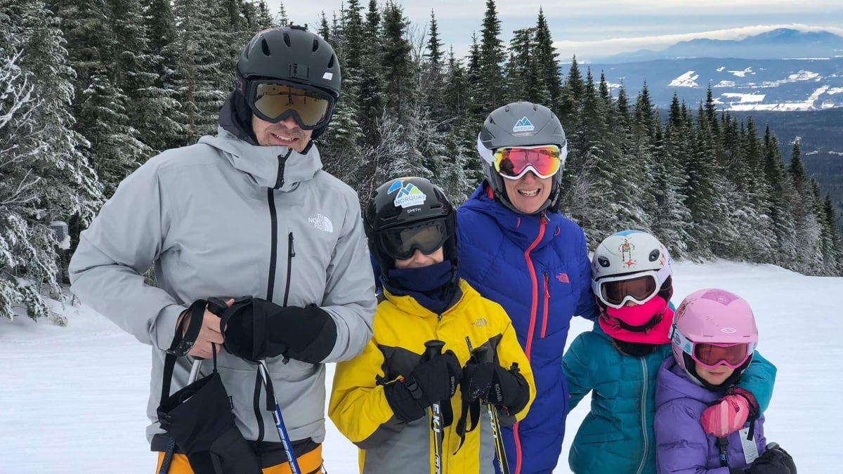 A family skiing at Mont Grand-Fonds