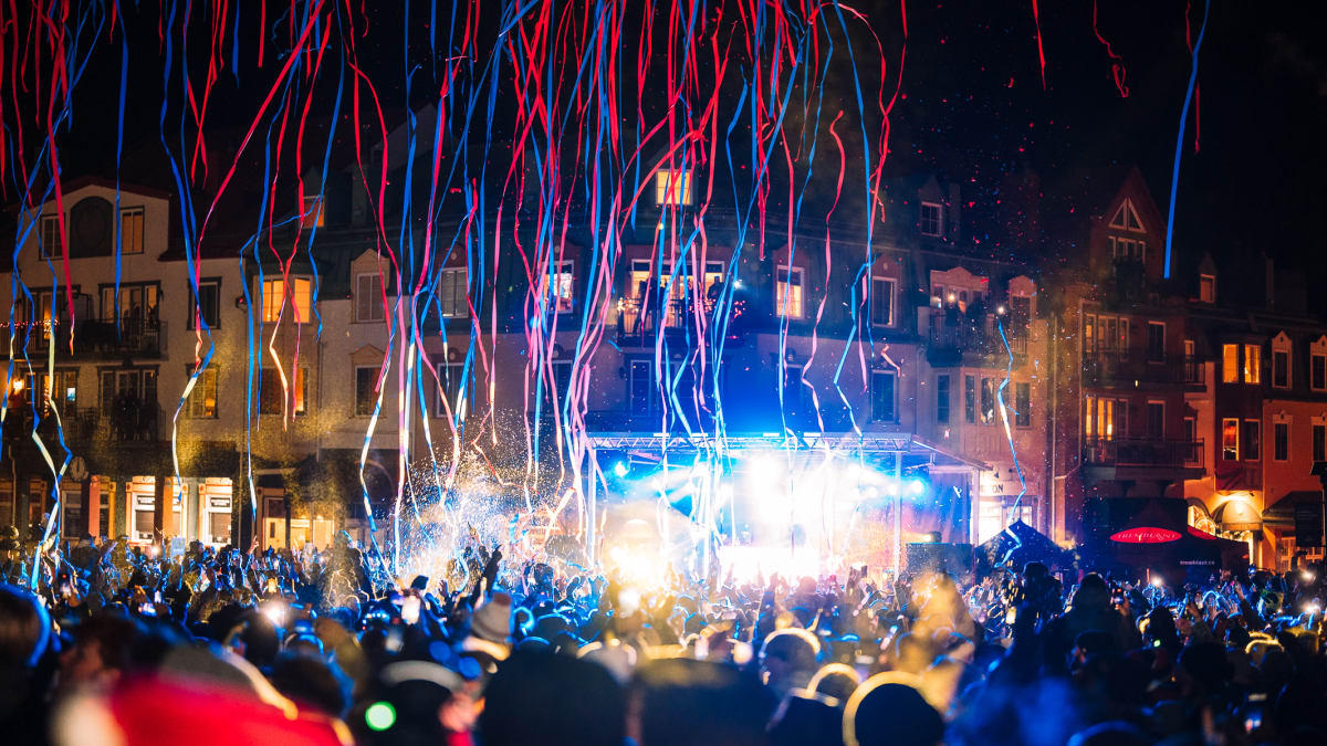 Confetti falling on a crowd gathered outdoors.