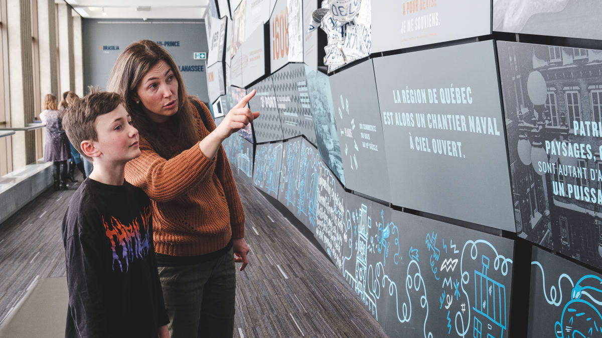 A mother and her son looking at an exhibit.