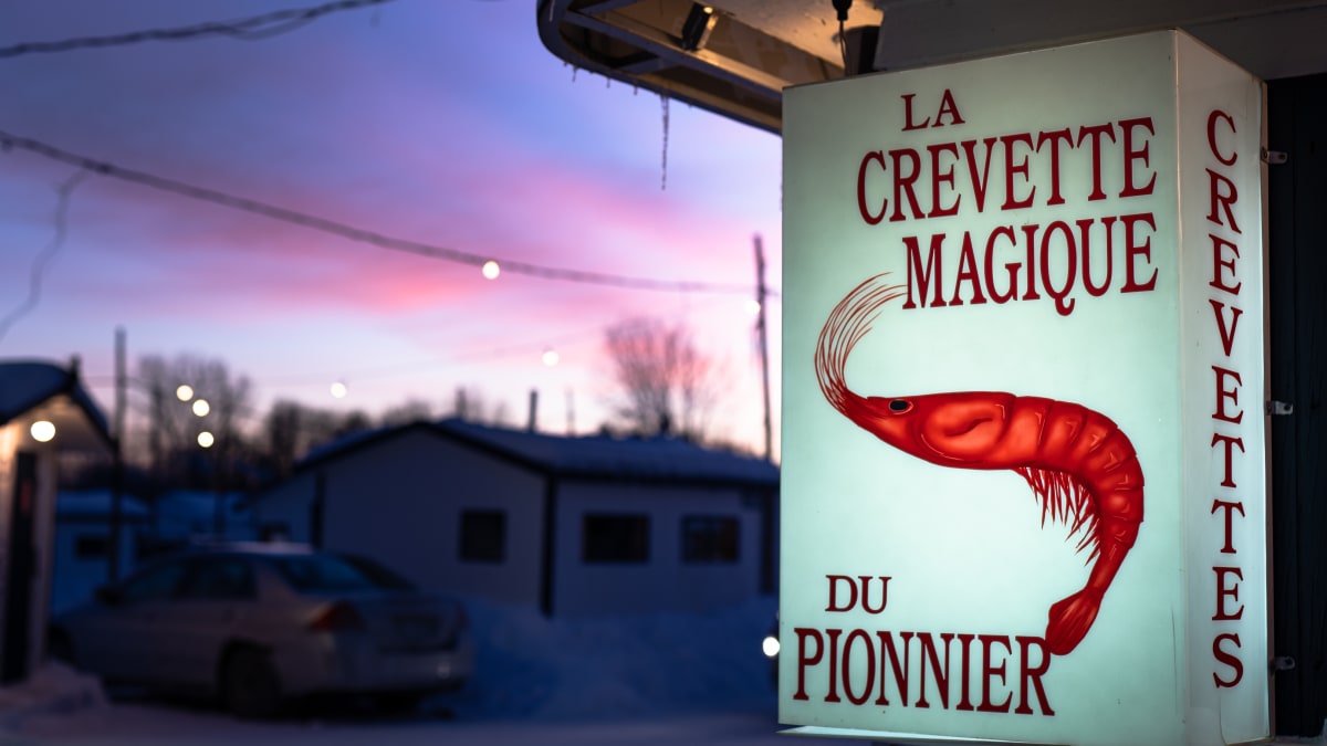 Affiche de pourvoyeur de pêche sur glace et village de pêche en début de soirée.