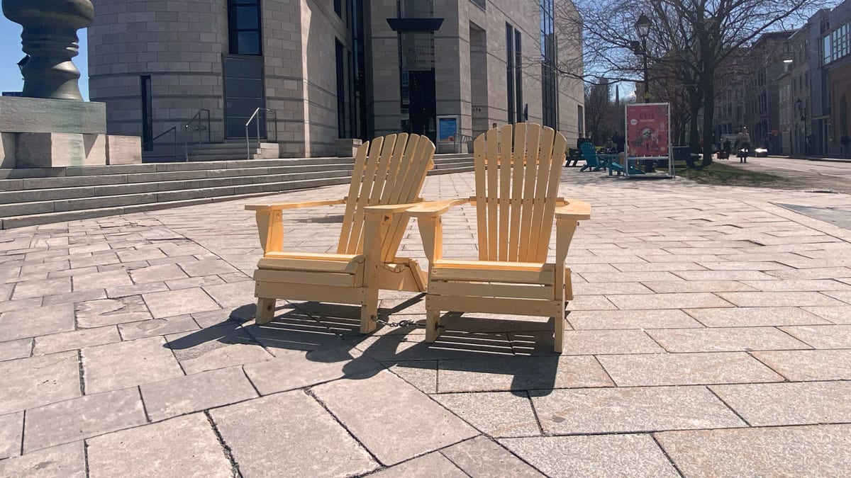 Two adirondac chairs outside Pointe-a-callière.