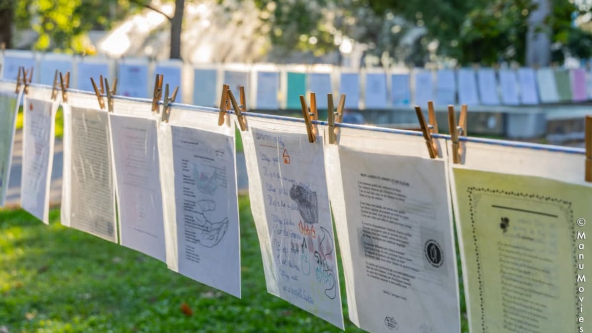 Outdoor rope on which poems have been clipped.