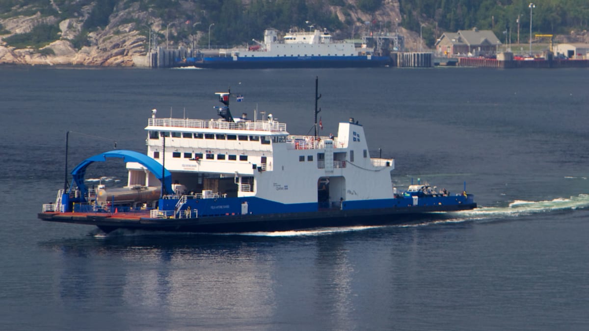 A ferry in the middle of a body of water.