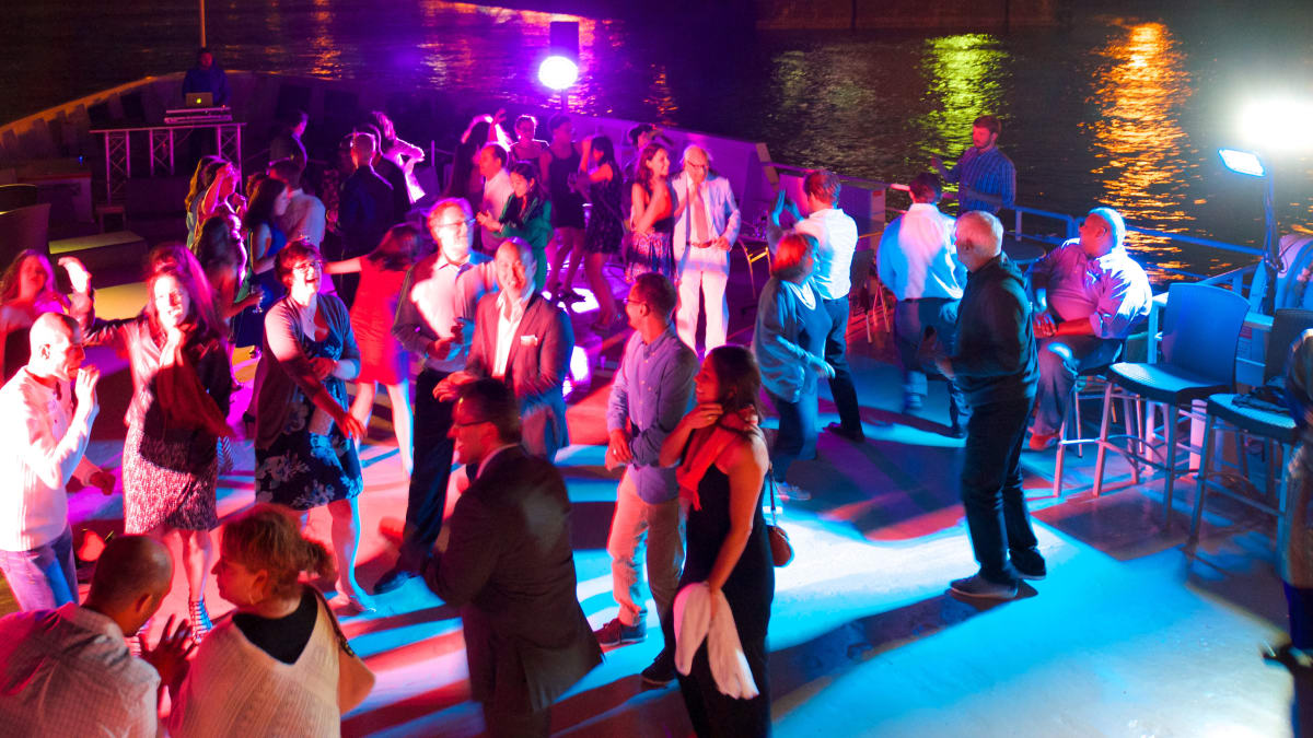 People dancing on a night cruise.