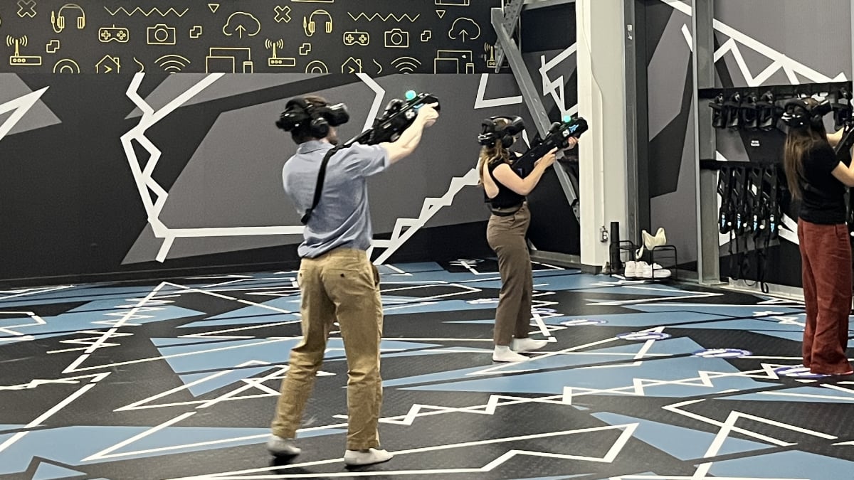 Three people in a virtual reality arena.