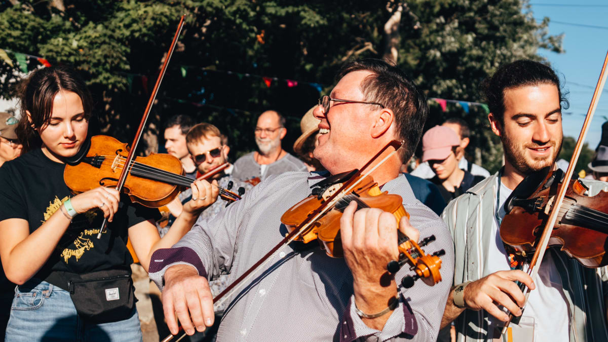 Musicians at the Ripon folk festival surrounded by a dancing audience.
