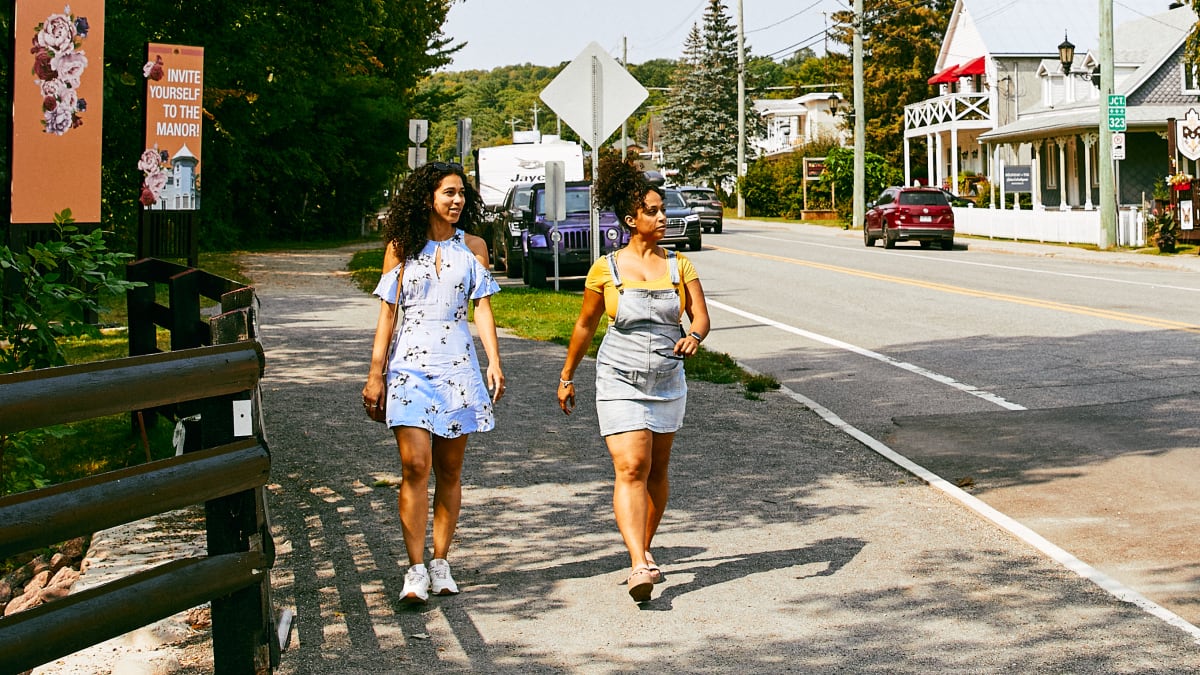 Two young girls exploring the main street in the village of Montebello.