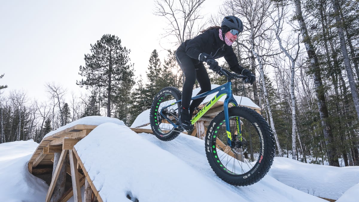 Woman riding a fatbike in the snow.