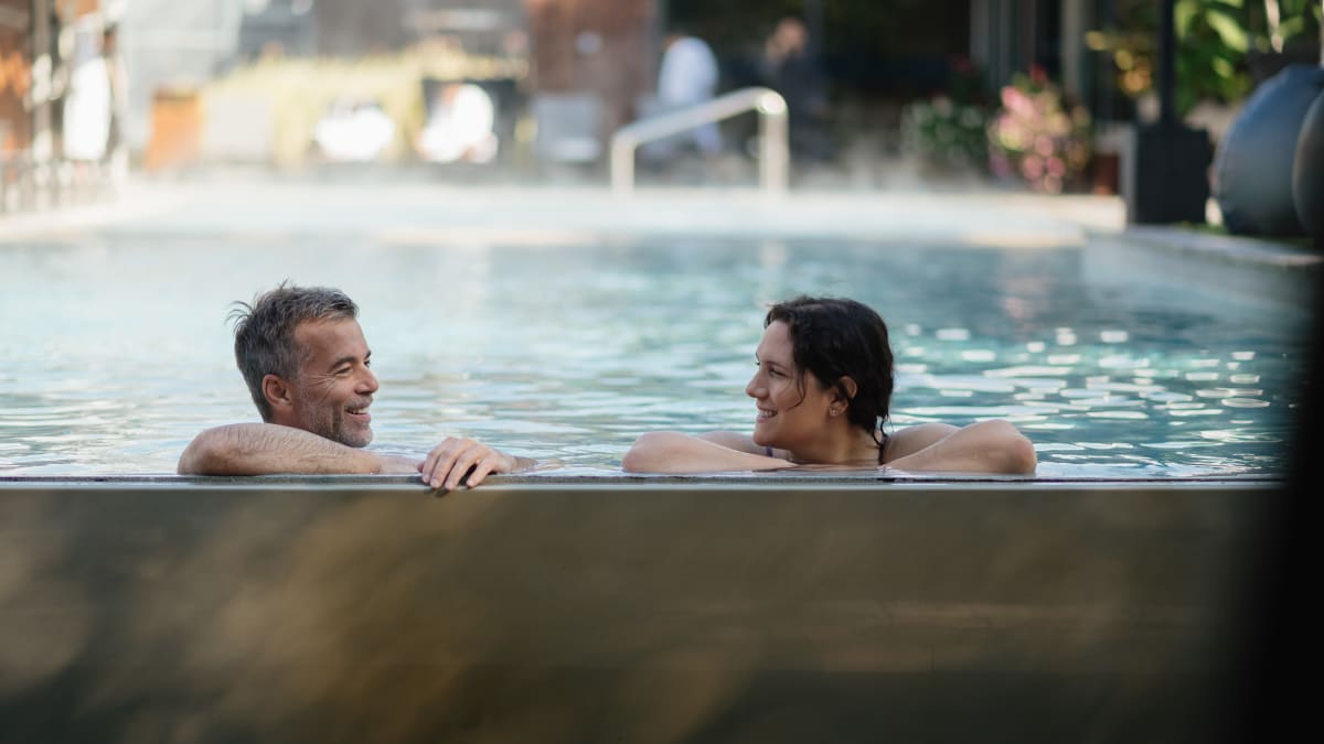 Two people soaking in a thermal pool.