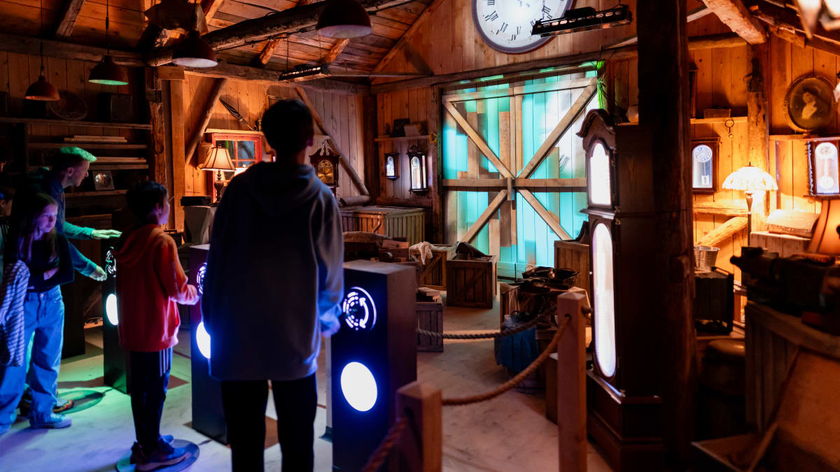 Family in the clock workshop at the Village Québécois d'Antan