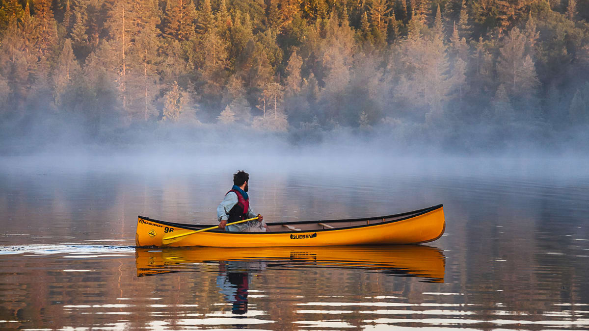 Yellow canoe on a misty lake in Abitibi-Témiscamingue.