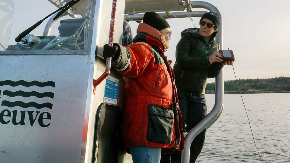 Two people on a boat in the sea.