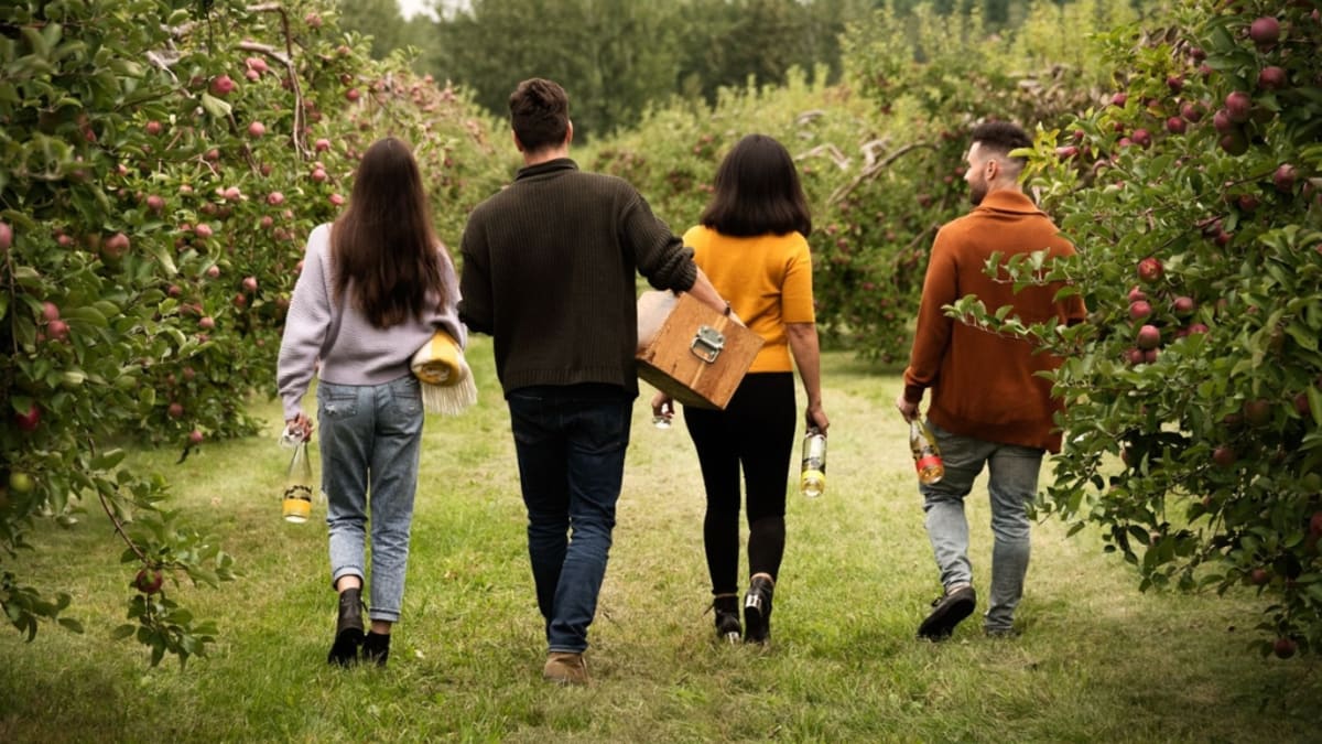 Family of four walking in the orchards
