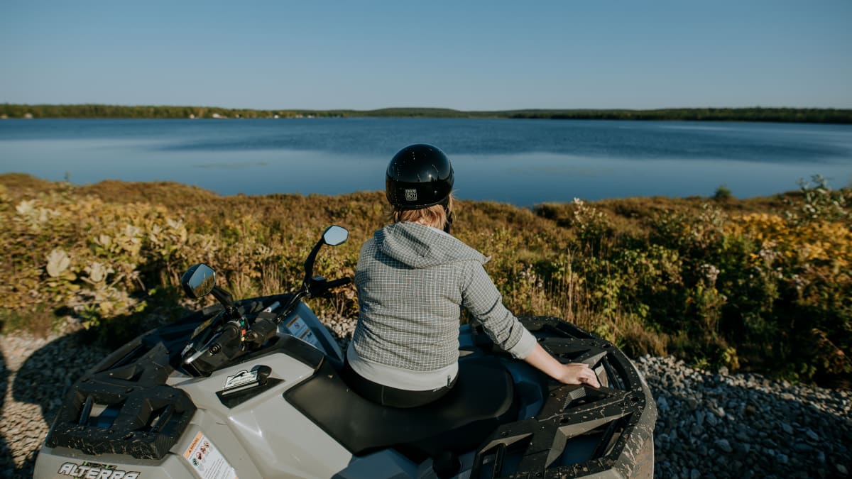Woman on an ATV looking at the landscape