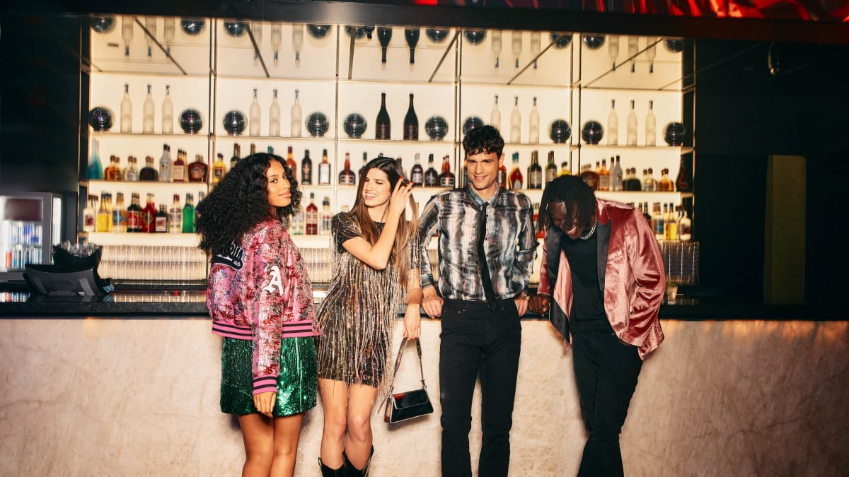 A group of friends in front of a bar.
