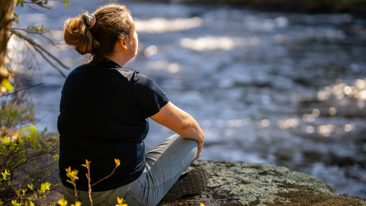 Femme assiste au bord de la Rivière du Loup au centre de villégiature Le Baluchon.