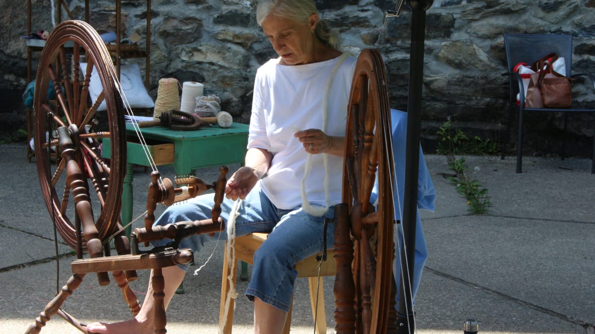 Woman operating a spinning machine