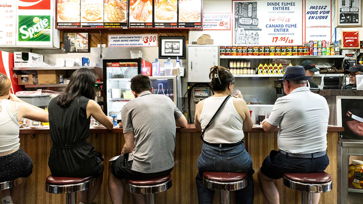 People sitting at the counter at Schwartz Deli