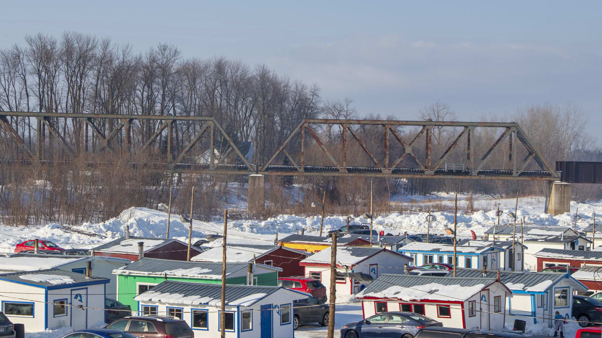 Group of colourful ice fishing cabins.
