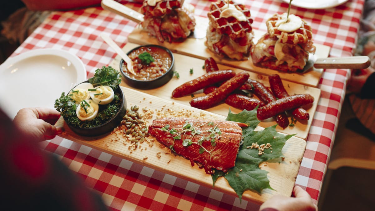 A tray of food served on a table covered with a checked tablecloth.