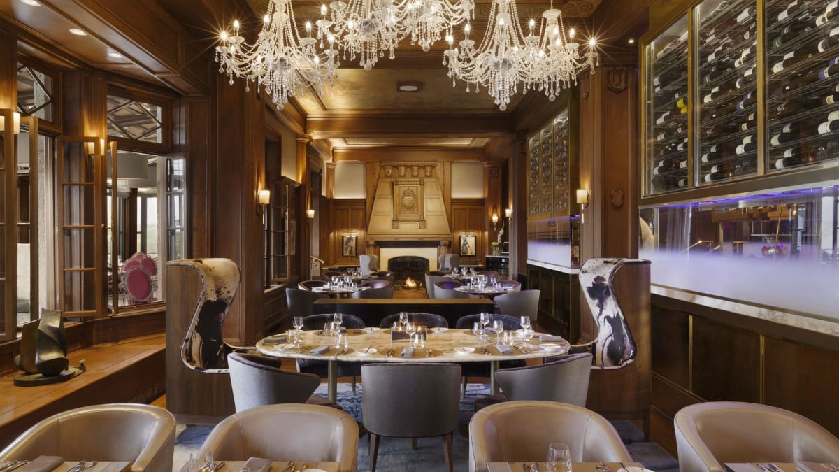 The dining room of the Champlain restaurant, featuring a large chandelier.