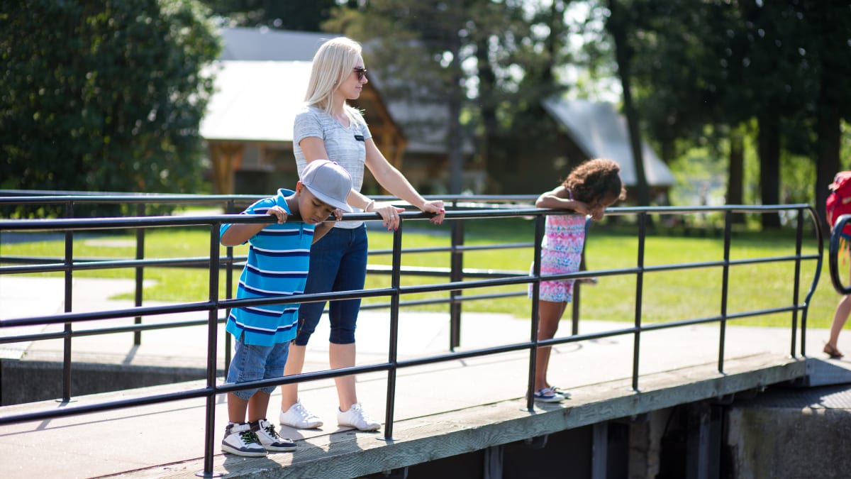 Mother and two children on the bridge at the canal