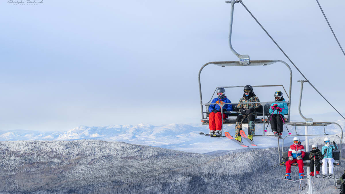 Skiers in the chairlift at Mont Grand-Fonds