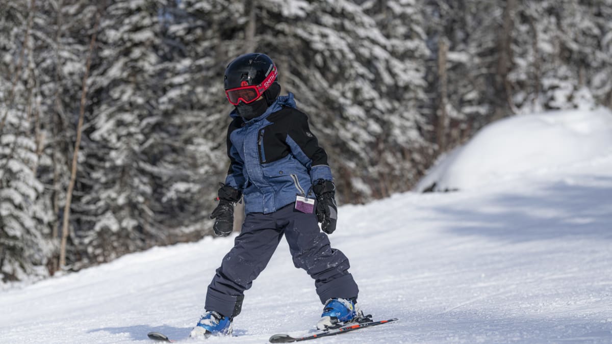 Child learning to ski.