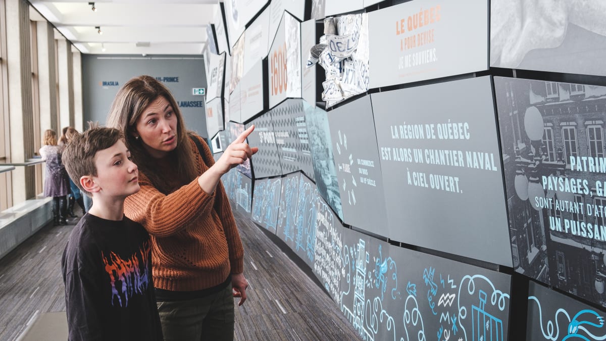 A mother and her son looking at an exhibit.