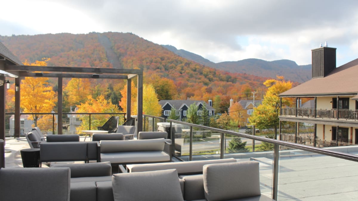 Mezzanine of the Espace 4 Saisons hotel with a view of the fall-coloured Mount Orford.