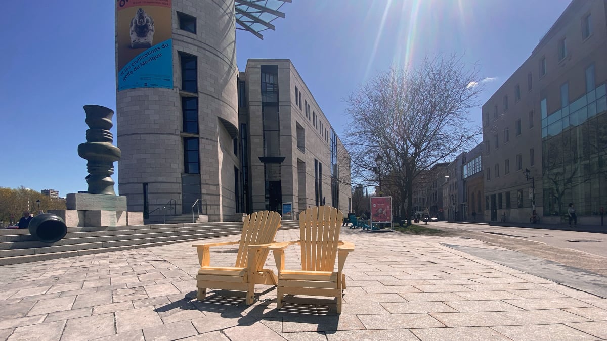 Two adirondac chairs outside Pointe-a-callière.