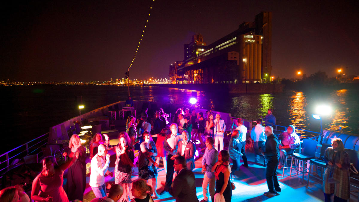 People dancing on a night cruise.
