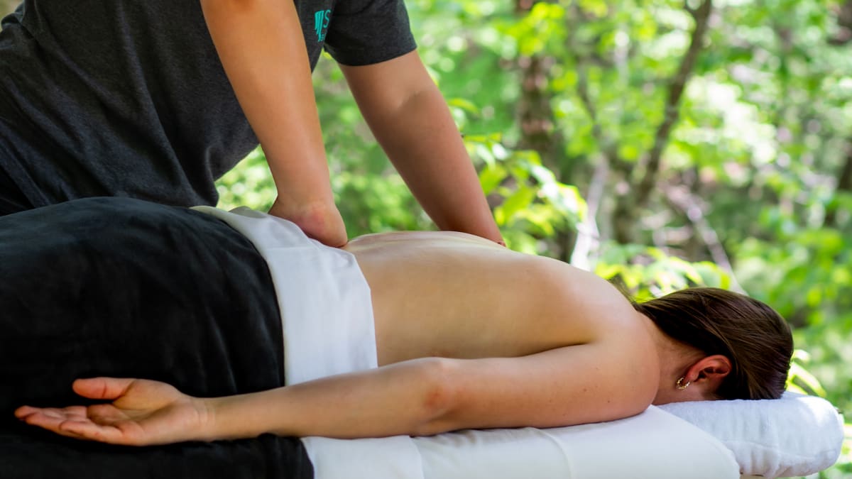 Woman getting a back massage on a massage table.