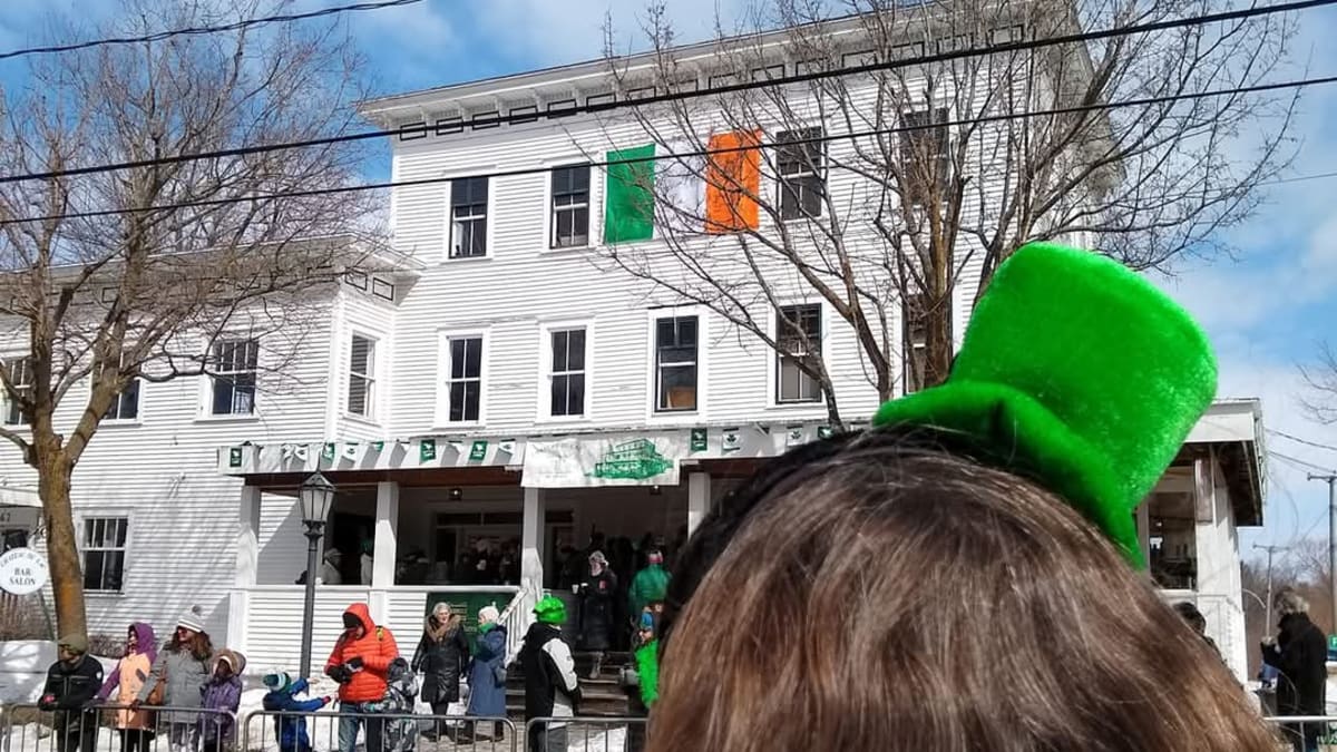 Young woman wearing a St Patrick's Day hat waiting for the parade to strart.