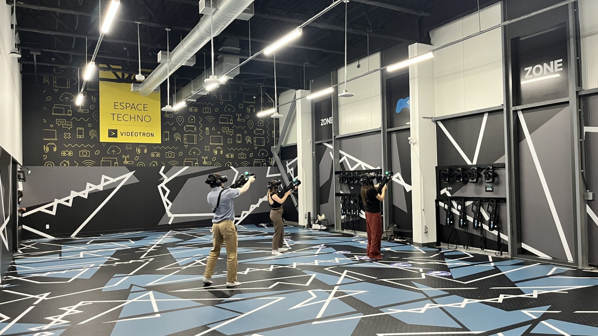 Three people in a virtual reality arena.