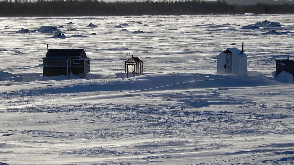 Ice fishing cabins on a frozen lake