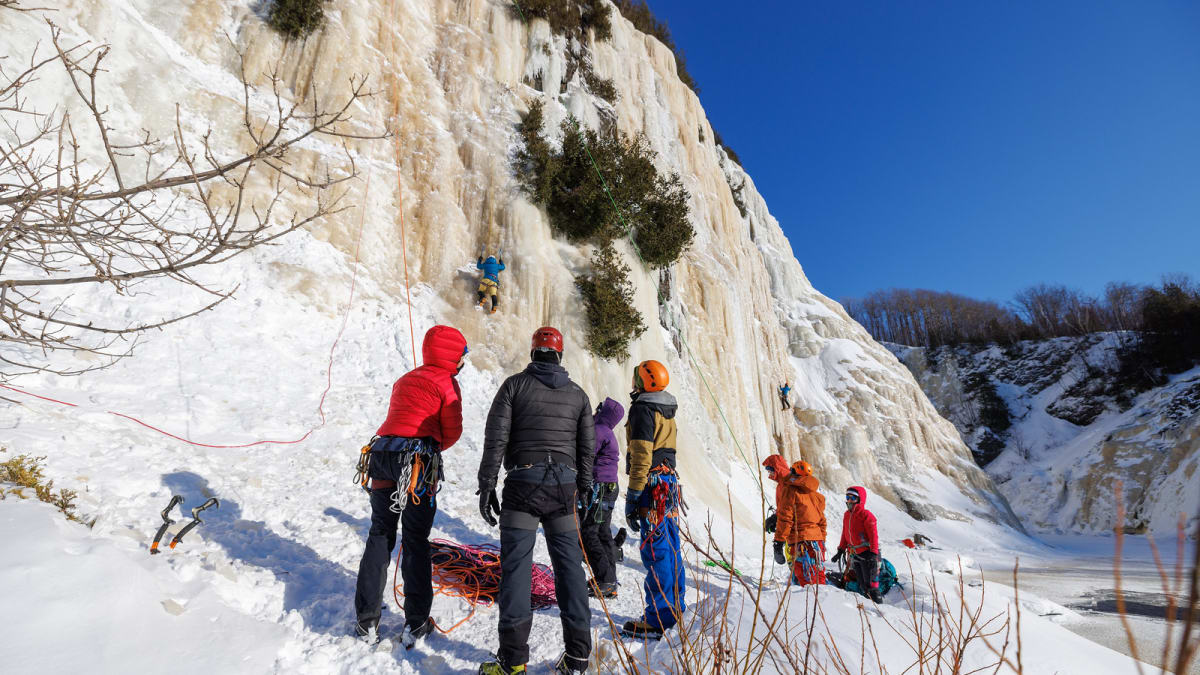 Group of climbers at the foot of an icy cliff