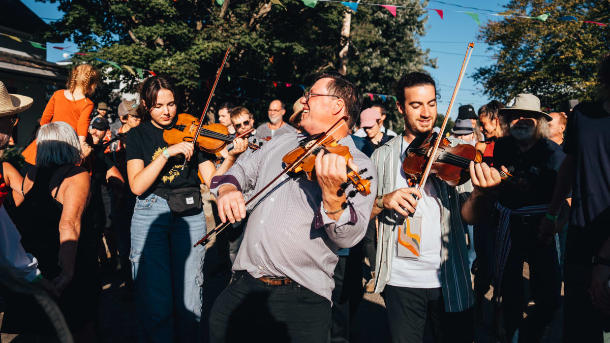 Musicians at the Ripon folk festival surrounded by a dancing audience.