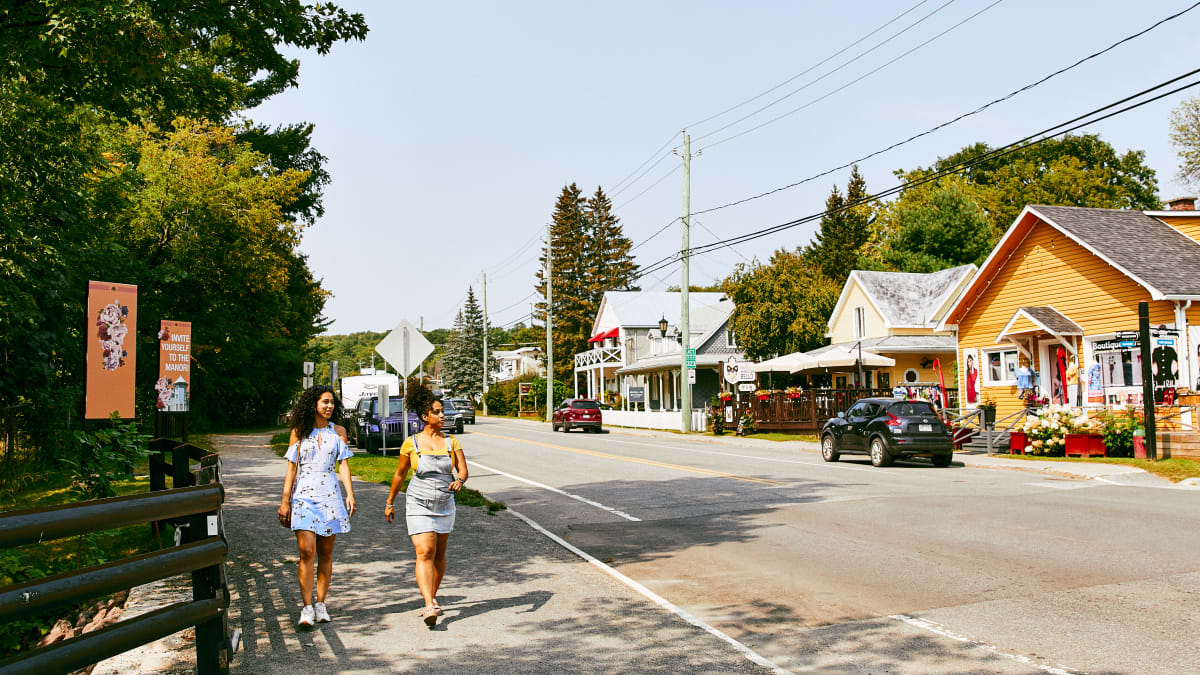 Two young girls exploring the main street in the village of Montebello.