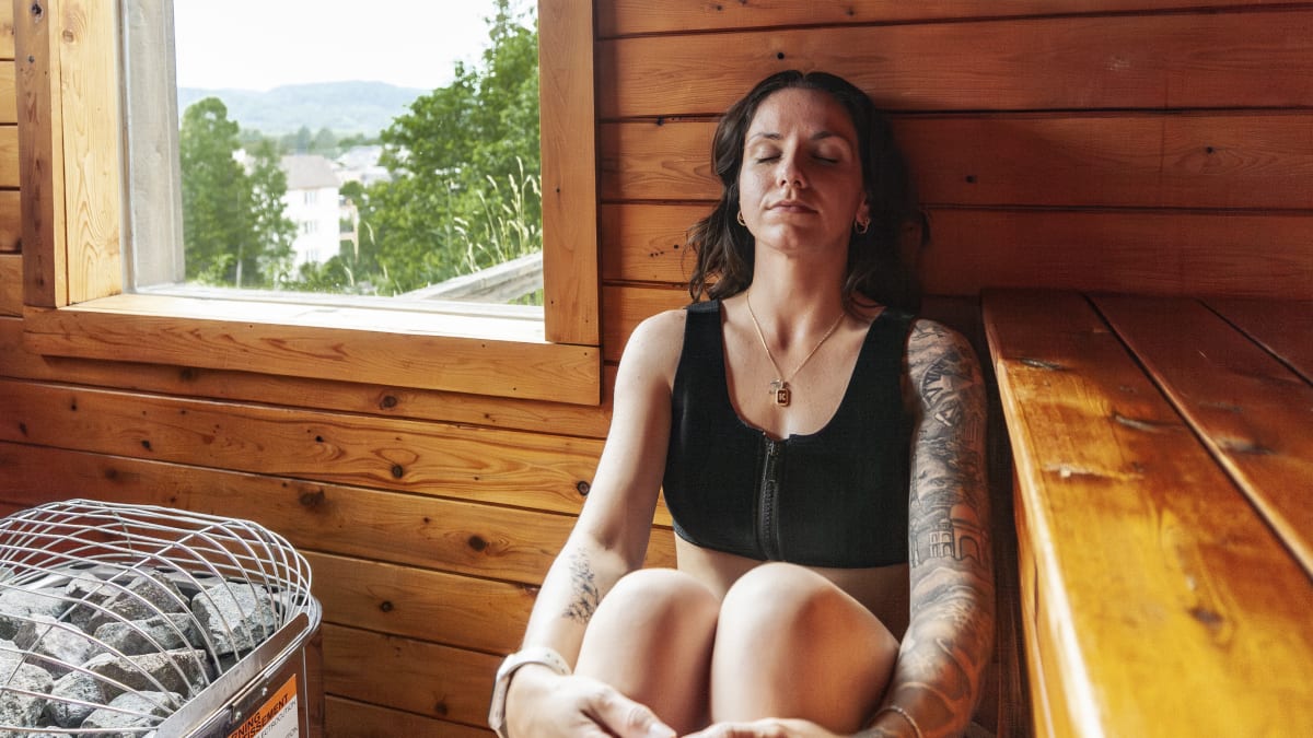 Femme relaxant dans un sauna en bois au AX Hôtel